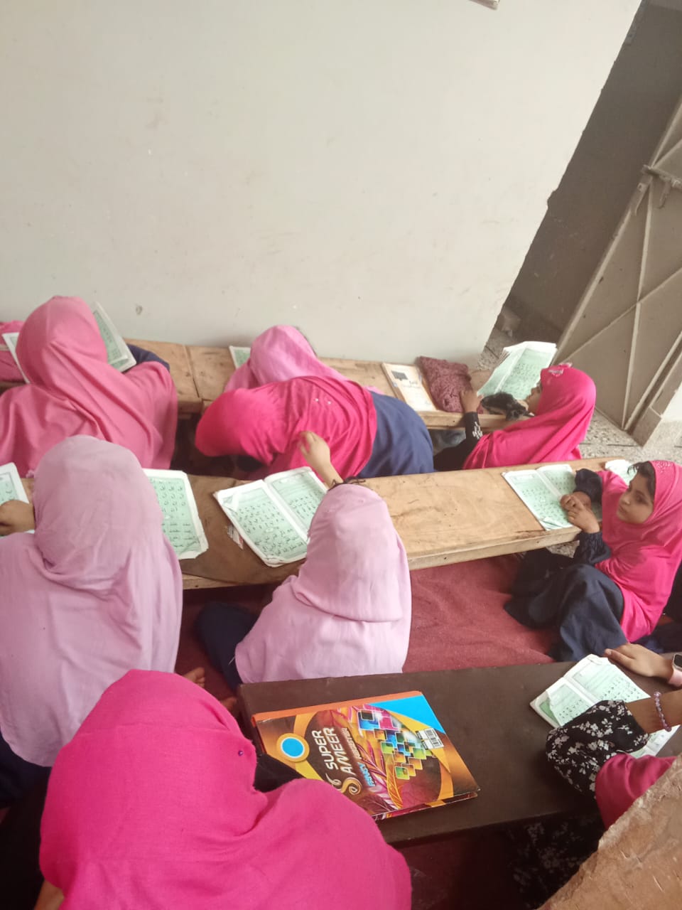 Girls studying together at an AHZ community learning location