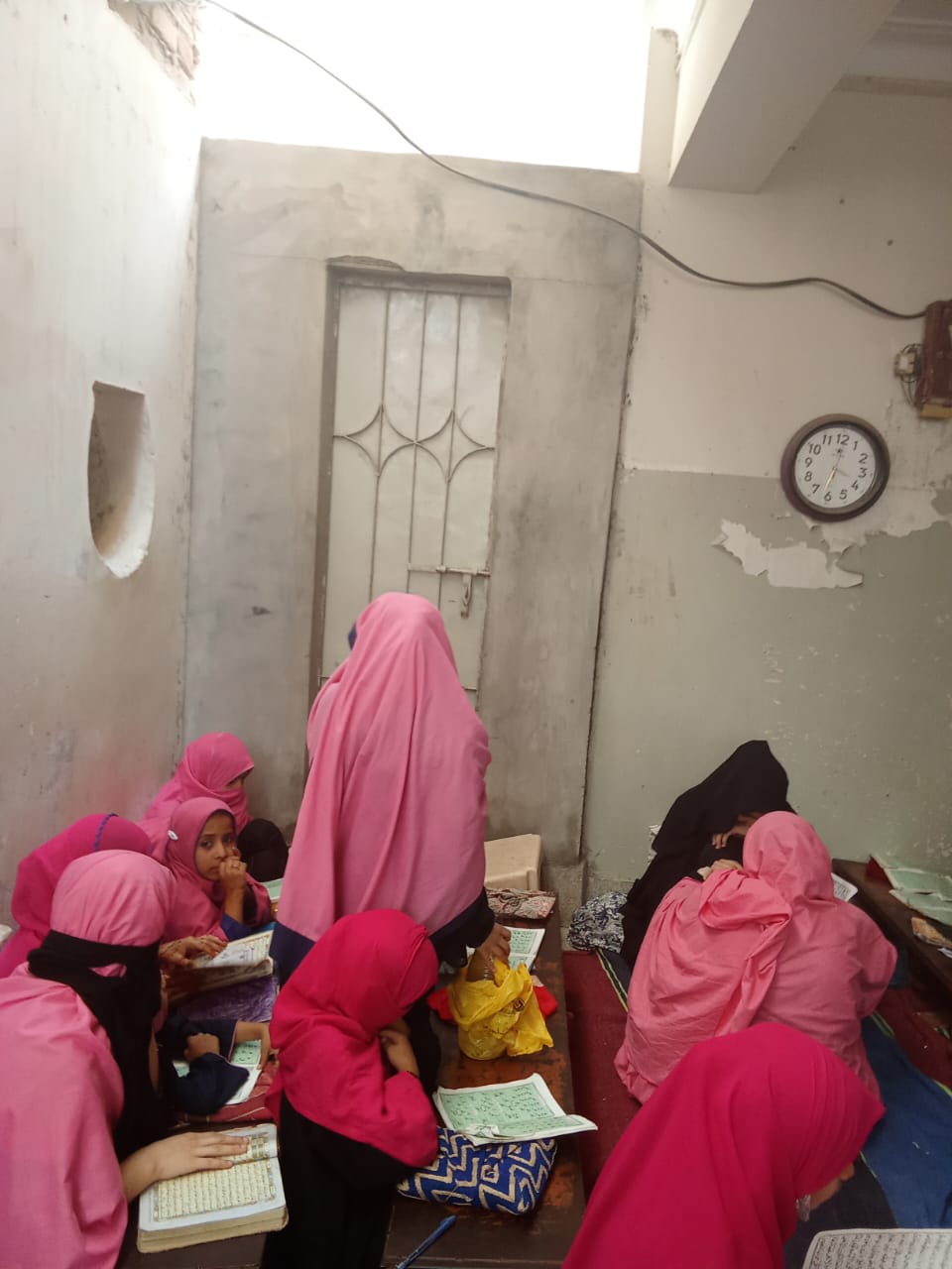 Girls reading in a crowded community classroom